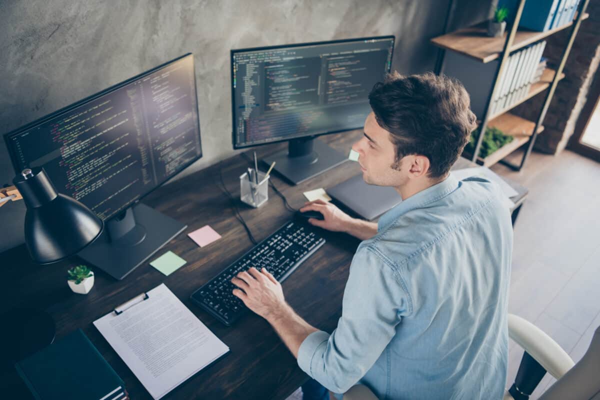 Man sitting at desk computer monitor
