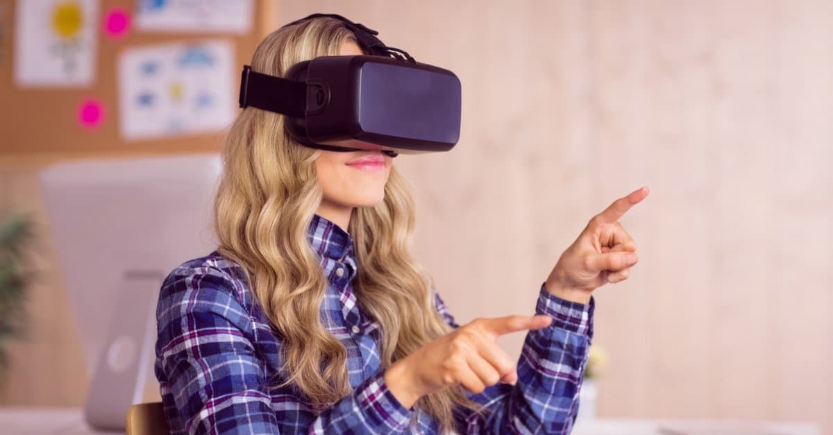 A casual worker using the Oculus Rift headset in her office. This was the first consumer version of the Rift headset released by Oculus.