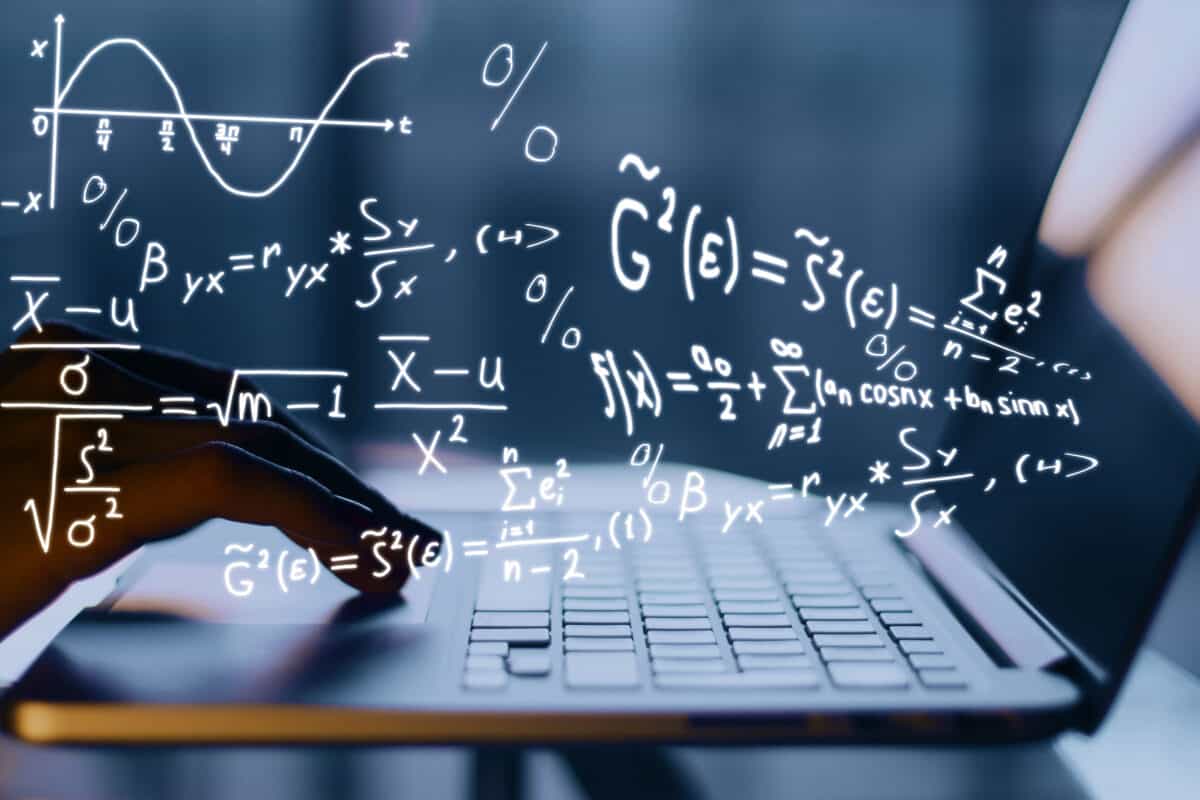 Mathematical equations above a laptop keyboard.