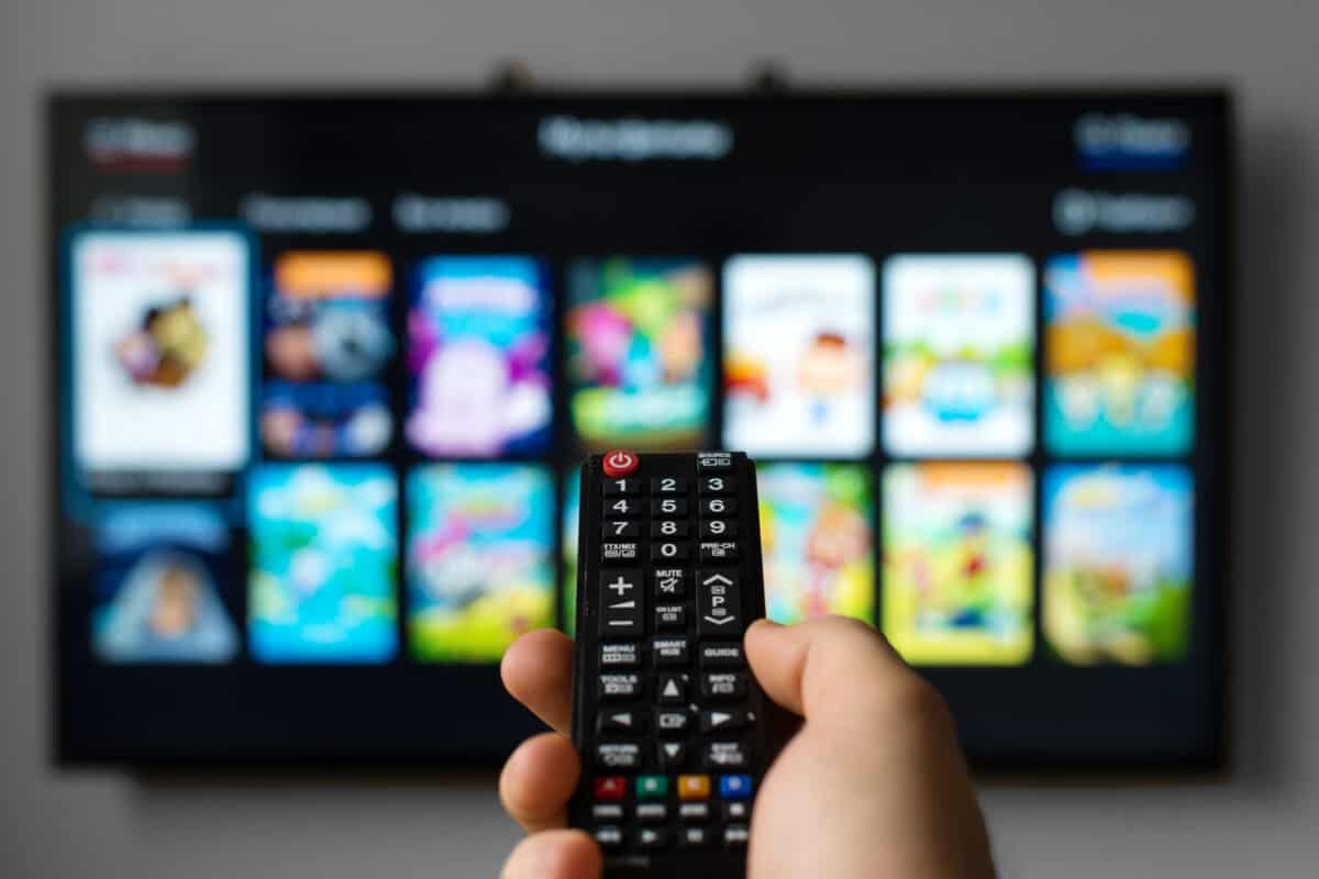 Man holding smart tv remote