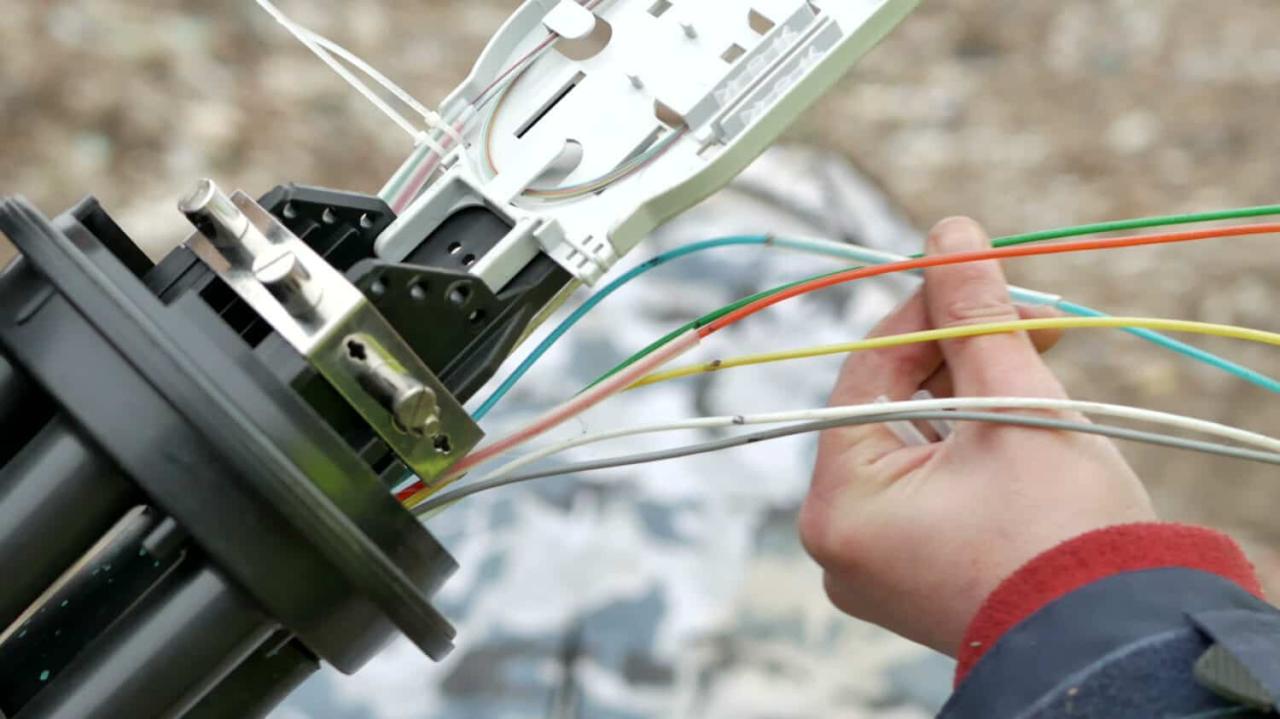 Technicians are installing optic fiber with cable ties.