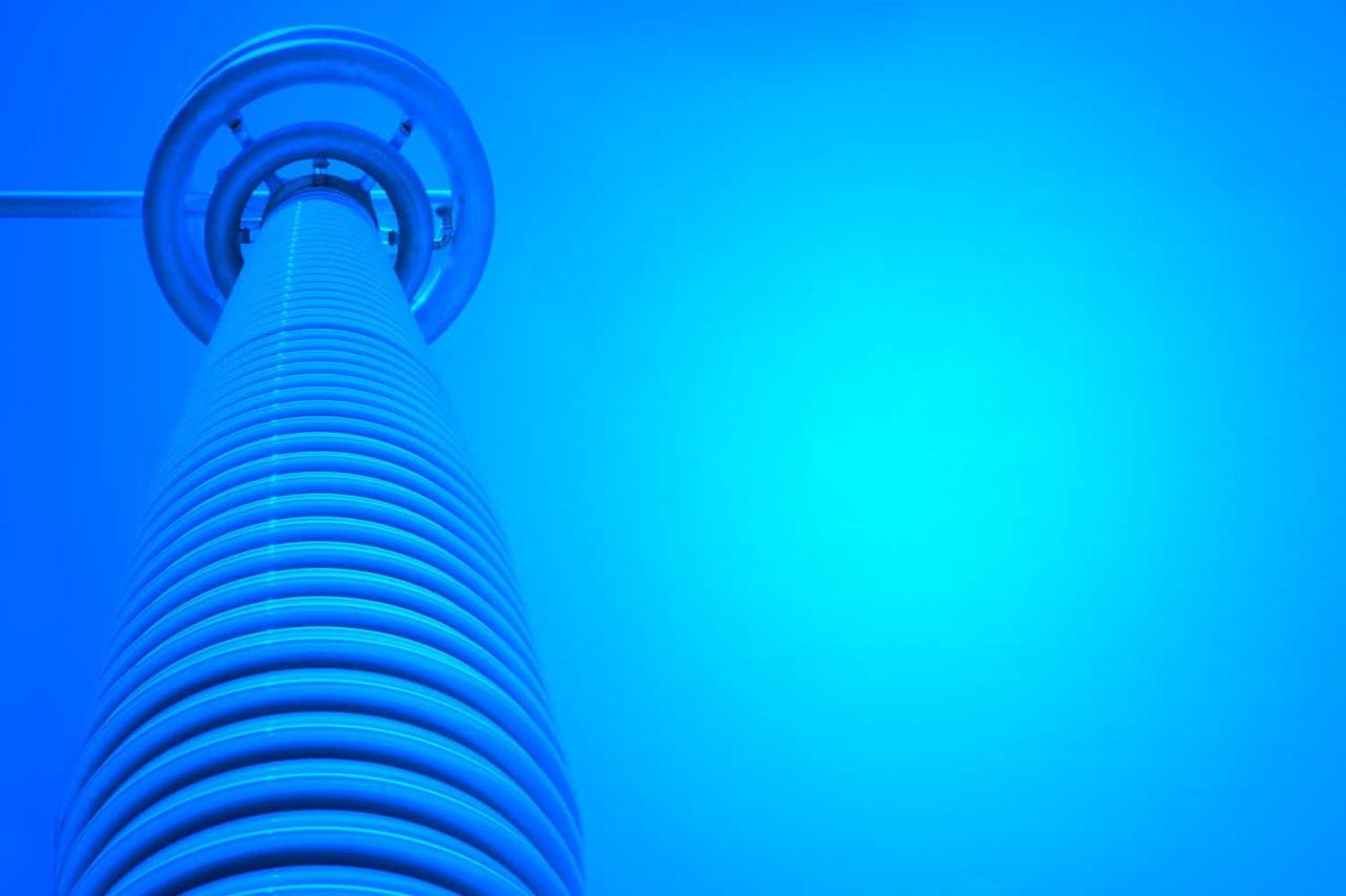 High voltage insulator for a hvdc power transmission in a blue background.