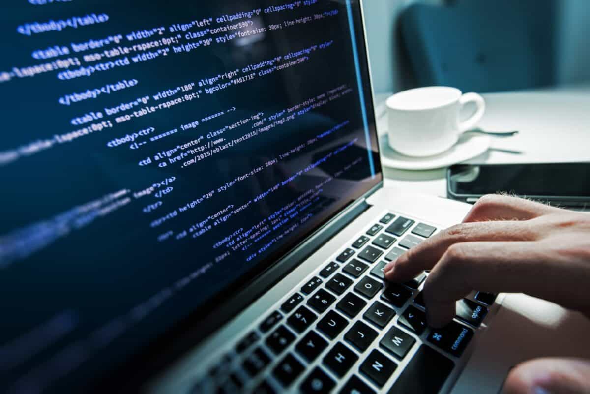 Programming Work Time. Programmer Typing New Lines of HTML Code. Laptop and Hand Closeup. Working Time. Web Design Business Concept.